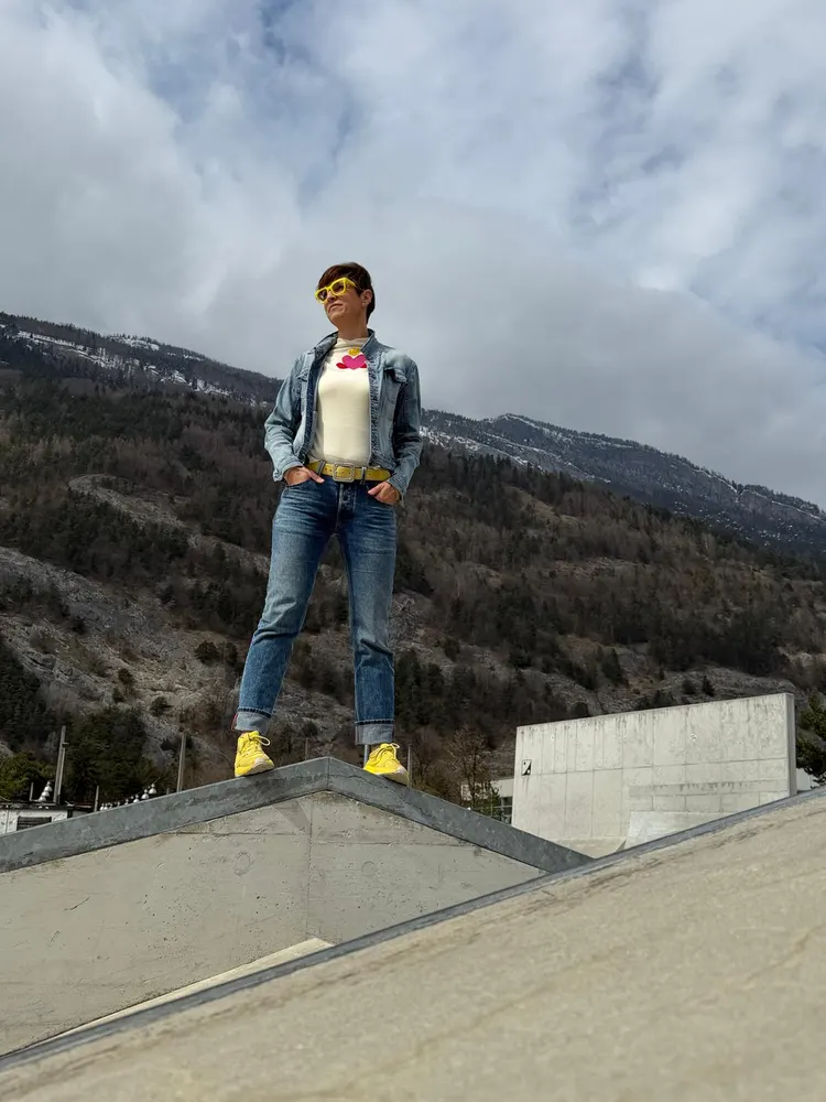 Katja mit gelben Sneakers vor Bergpanorama